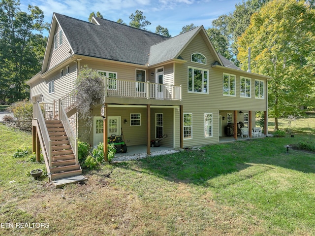 back of house with a patio area, a lawn, a wooden deck, and stairs