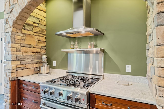 kitchen featuring range hood, light countertops, open shelves, and high end stainless steel range