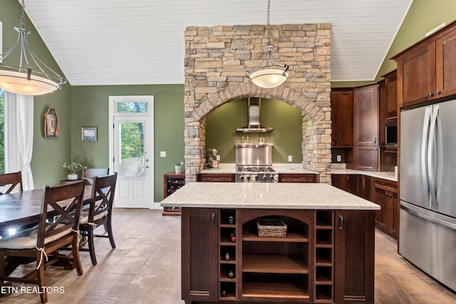 kitchen with open shelves, a kitchen island, appliances with stainless steel finishes, wall chimney range hood, and lofted ceiling