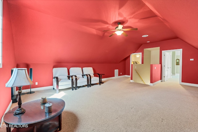 interior space featuring an upstairs landing, baseboards, lofted ceiling, and carpet floors