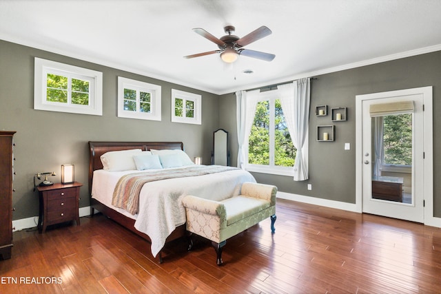 bedroom with crown molding, baseboards, dark wood-style flooring, and ceiling fan