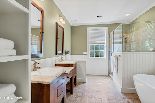 full bathroom featuring visible vents, a shower stall, a wainscoted wall, a freestanding tub, and vanity