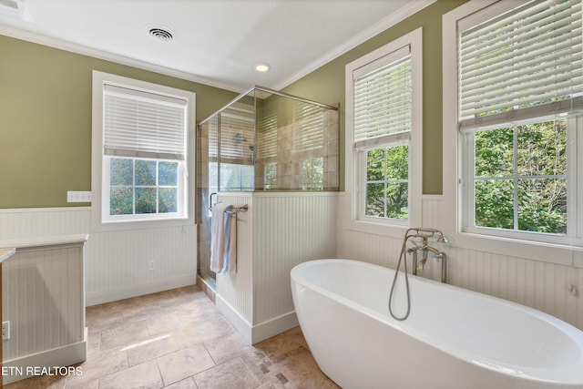 full bath featuring a stall shower, visible vents, a freestanding tub, and wainscoting