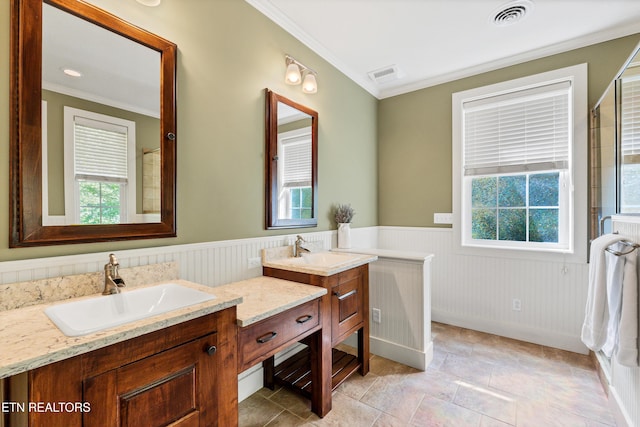 bathroom featuring visible vents, wainscoting, and plenty of natural light