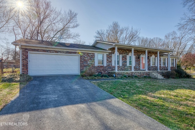 view of front of house with brick siding, concrete driveway, a garage, and a front yard