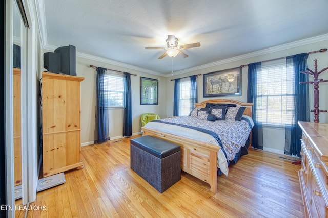 bedroom with multiple windows, light wood-style flooring, and ornamental molding