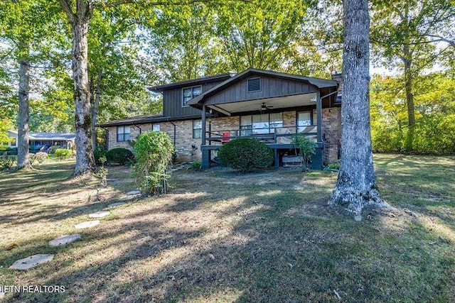 view of front of property featuring stone siding and a front lawn