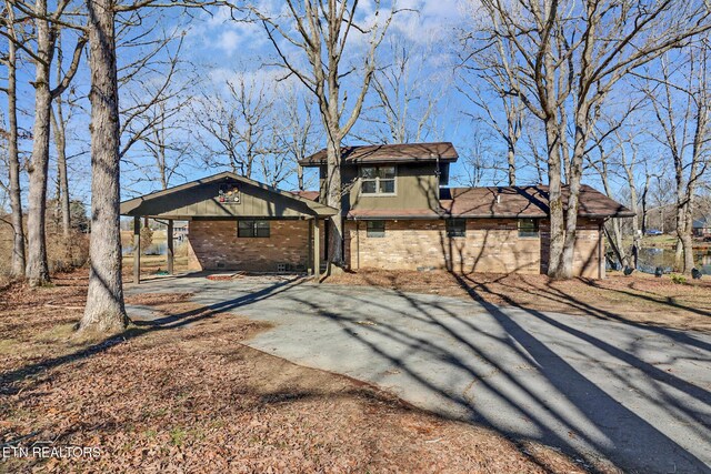 2024 Cravens Dr, Crossville, TN 38572 - back of property with brick siding and asphalt driveway
