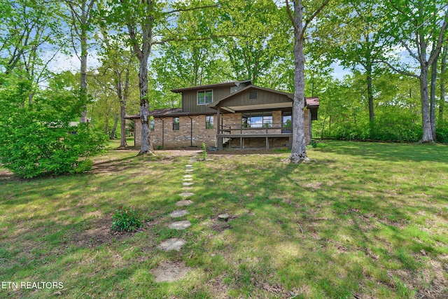 2024 Cravens Dr, Crossville, TN 38572 - back of property featuring a lawn and brick siding