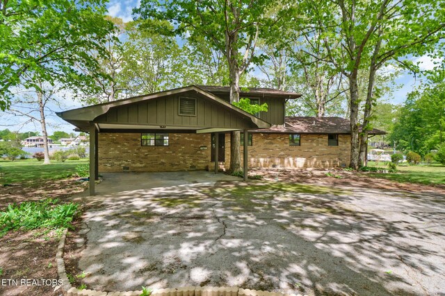 2024 Cravens Dr, Crossville, TN 38572 - back of property featuring brick siding and a carport