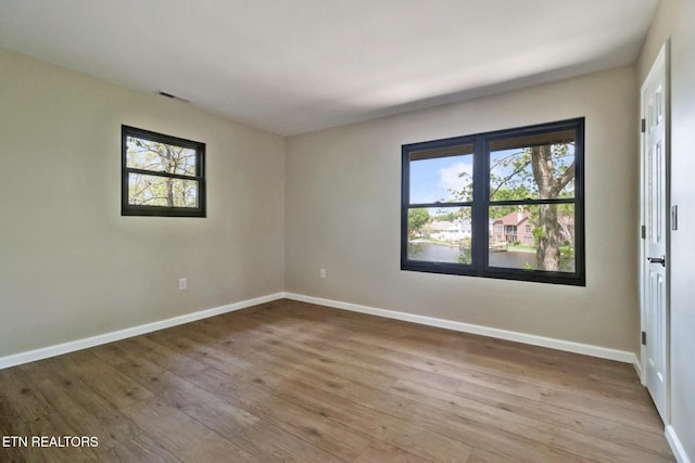 2024 Cravens Dr, Crossville, TN 38572 - empty room with healthy amount of natural light, wood finished floors, and baseboards