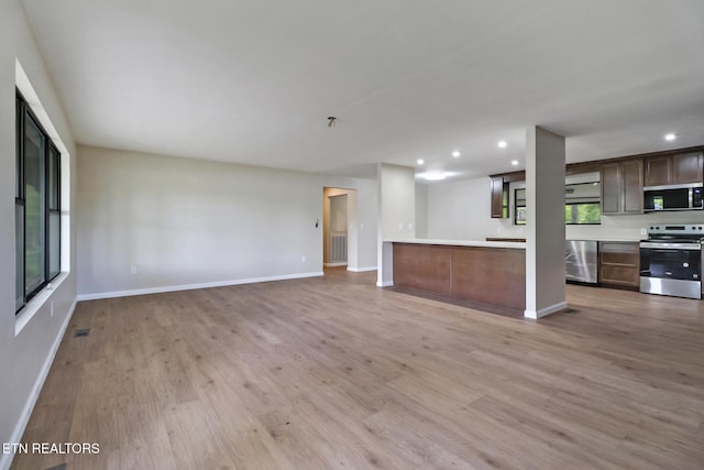 2024 Cravens Dr, Crossville, TN 38572 - unfurnished living room with light wood-style floors, baseboards, and recessed lighting