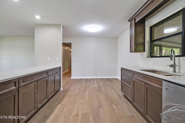 2024 Cravens Dr, Crossville, TN 38572 - kitchen with a sink, light wood-style flooring, light countertops, baseboards, and dark brown cabinetry