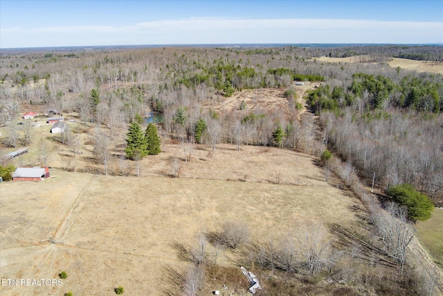 birds eye view of property featuring a wooded view and a rural view