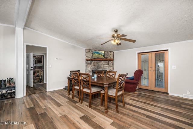 dining area featuring french doors, wood finished floors, visible vents, and crown molding