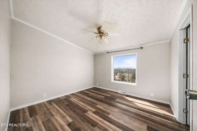 spare room with ornamental molding, dark wood-type flooring, visible vents, and a ceiling fan