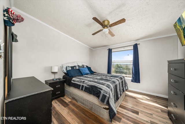 bedroom with baseboards, ceiling fan, ornamental molding, dark wood-type flooring, and a textured ceiling