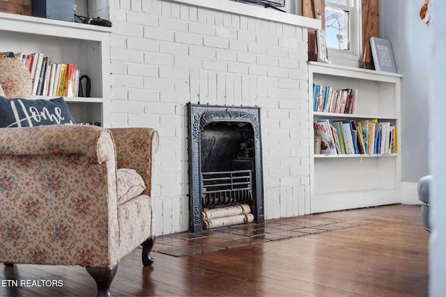 living area featuring a fireplace and wood finished floors