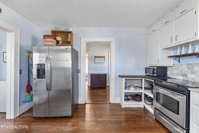 kitchen featuring dark wood-type flooring, stainless steel appliances, light countertops, white cabinetry, and backsplash