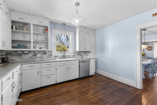 kitchen with a sink, white cabinetry, light countertops, backsplash, and dishwasher