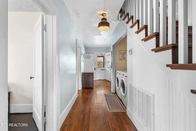 hallway featuring visible vents, stairway, dark wood-type flooring, independent washer and dryer, and baseboards