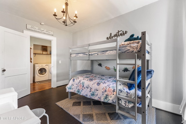 bedroom featuring baseboards, separate washer and dryer, wood finished floors, and an inviting chandelier