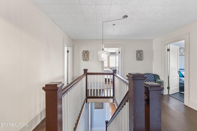 stairs with baseboards and wood finished floors