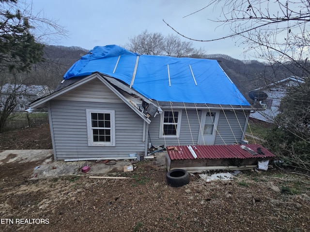 back of property featuring a mountain view