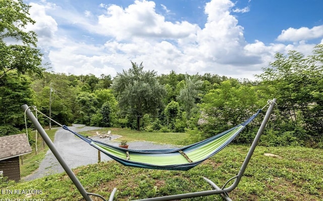 view of play area featuring a wooded view