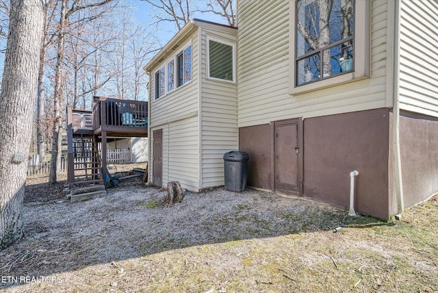 view of side of property featuring stairway, a deck, and stucco siding