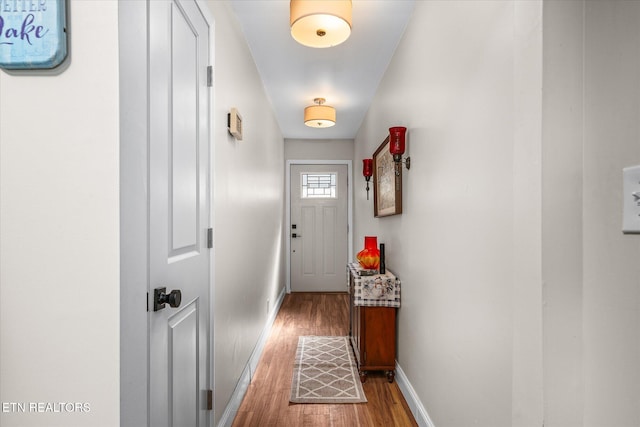 entryway with light wood-style flooring and baseboards