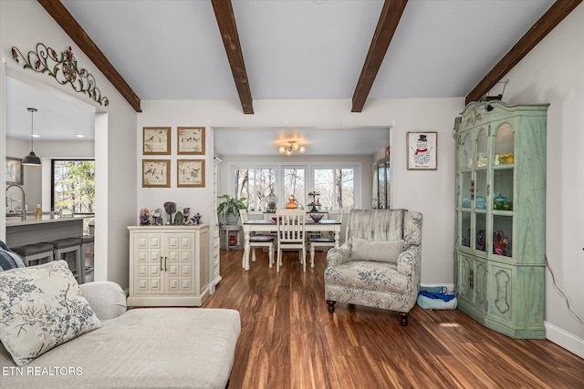 living room with beamed ceiling, wood finished floors, and baseboards