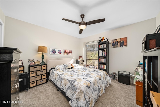 bedroom featuring ceiling fan and light colored carpet