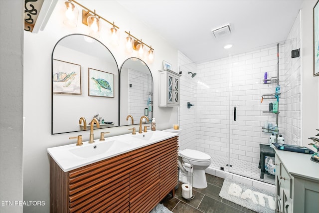 bathroom with double vanity, visible vents, and a sink