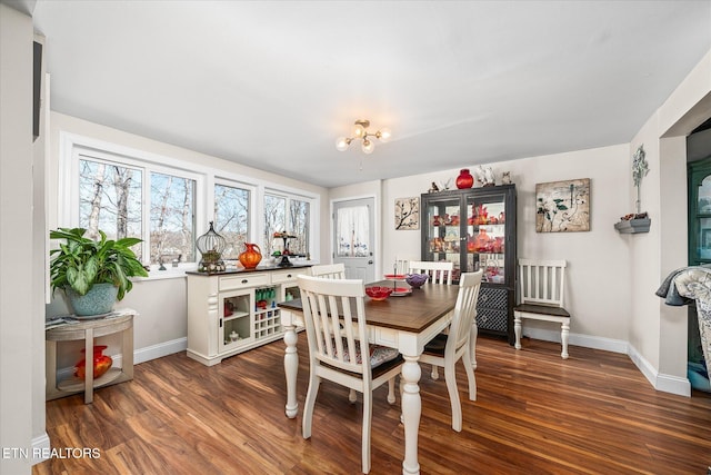 dining space featuring baseboards and wood finished floors