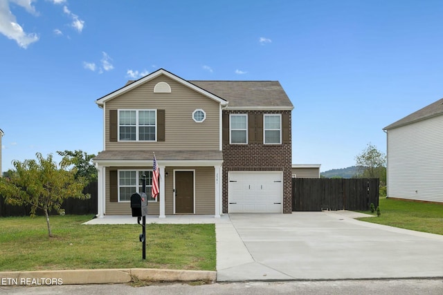 traditional-style house featuring brick siding, concrete driveway, fence, a garage, and a front lawn