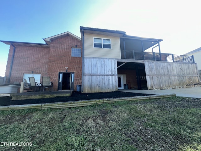 rear view of house with brick siding