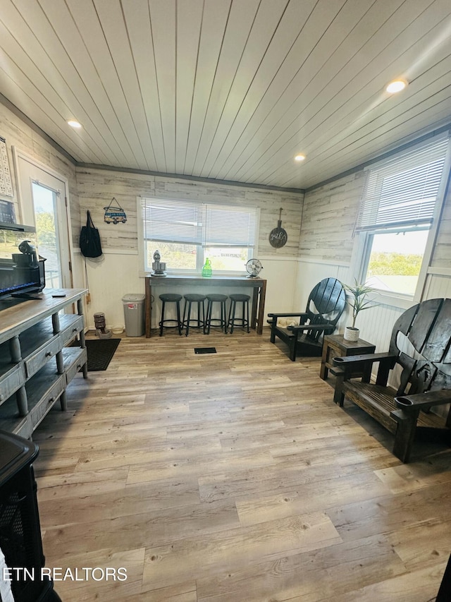 interior space with recessed lighting, wooden ceiling, wood walls, and light wood finished floors