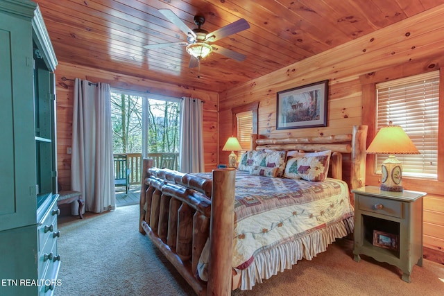 carpeted bedroom with access to outside, wood ceiling, and wooden walls