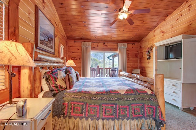 carpeted bedroom with wood ceiling, vaulted ceiling, and wooden walls