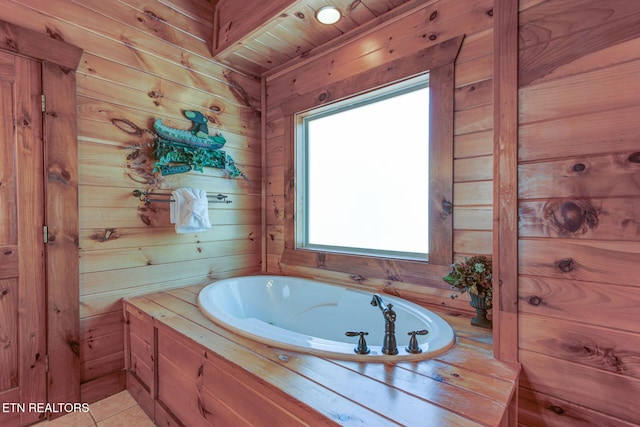 full bathroom with a garden tub, wood walls, and tile patterned floors