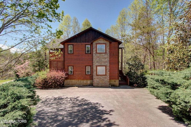 view of home's exterior with driveway and board and batten siding