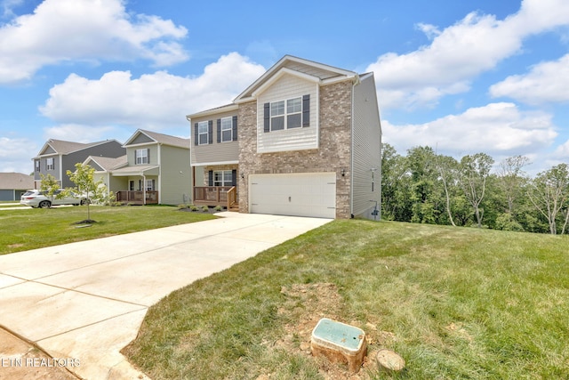 943 Utopia Ln, Knoxville, TN 37932 - view of front of home featuring an attached garage, concrete driveway, brick siding, and a front lawn