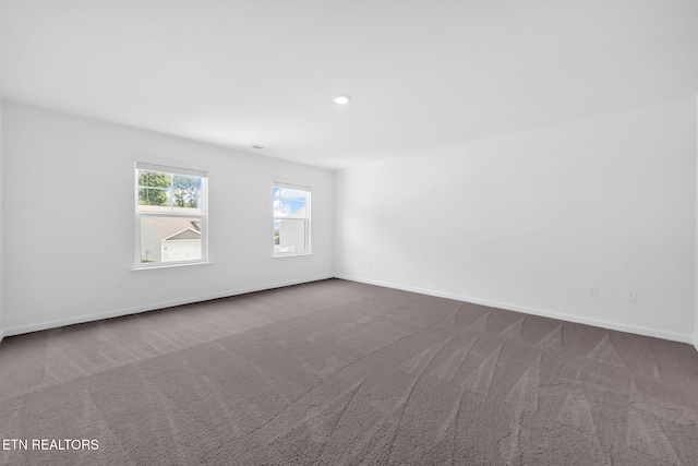 943 Utopia Ln, Knoxville, TN 37932 - spare room featuring dark colored carpet and baseboards