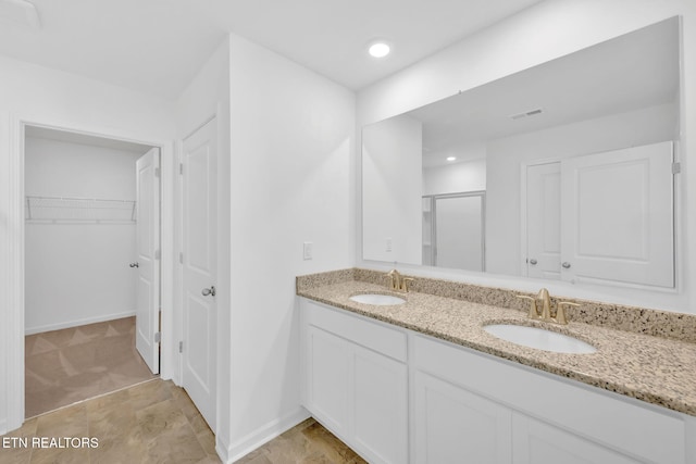 943 Utopia Ln, Knoxville, TN 37932 - bathroom with a stall shower, double vanity, a spacious closet, baseboards, and recessed lighting