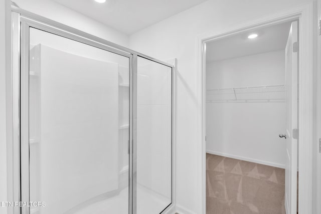 943 Utopia Ln, Knoxville, TN 37932 - bathroom featuring a stall shower, a spacious closet, and recessed lighting