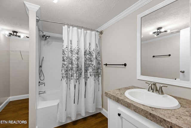 bathroom featuring a textured ceiling, shower / bath combination with curtain, ornamental molding, and wood finished floors