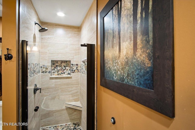 bathroom with tiled shower