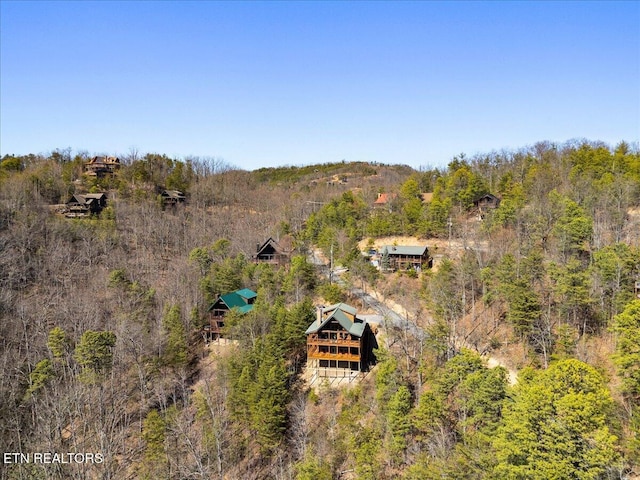 drone / aerial view featuring a wooded view