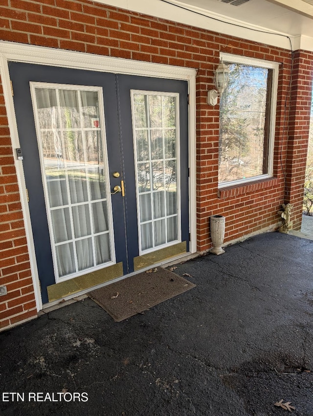 property entrance with brick siding